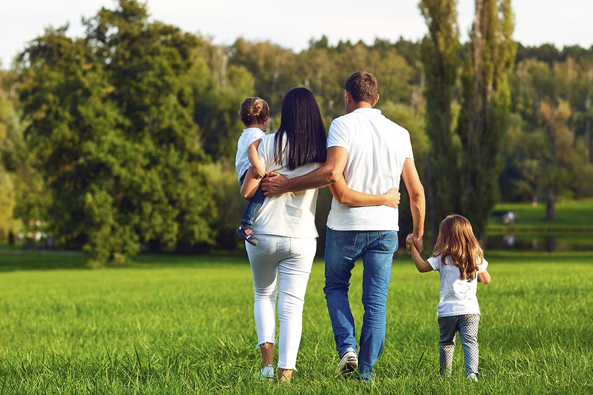 Happy young family walking in nature